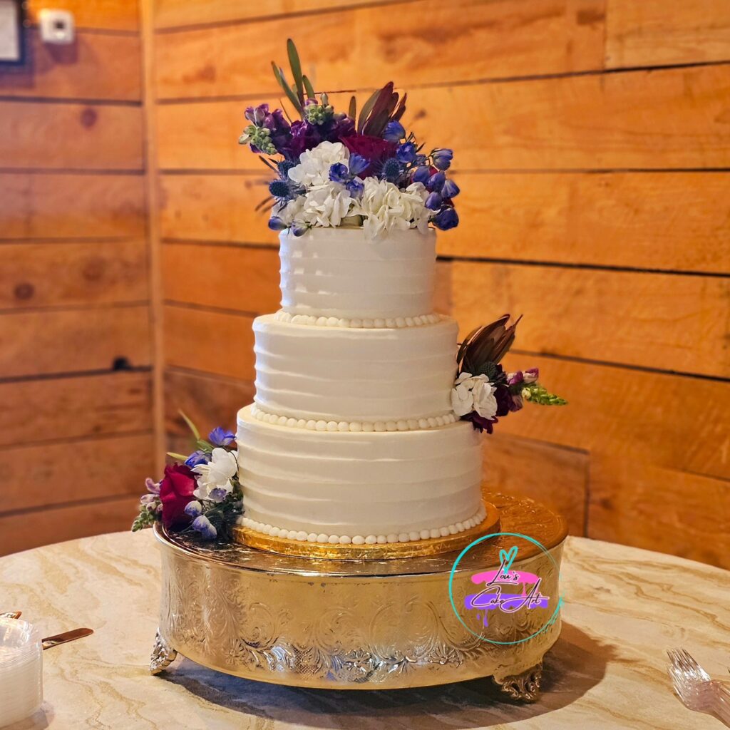three tier wedding cake with floral accents